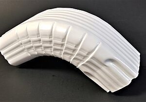 A white plastic object is bent to make it look like a curved wall.