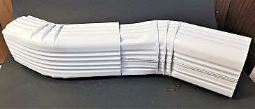 A bunch of white plastic pipes sitting on top of each other.